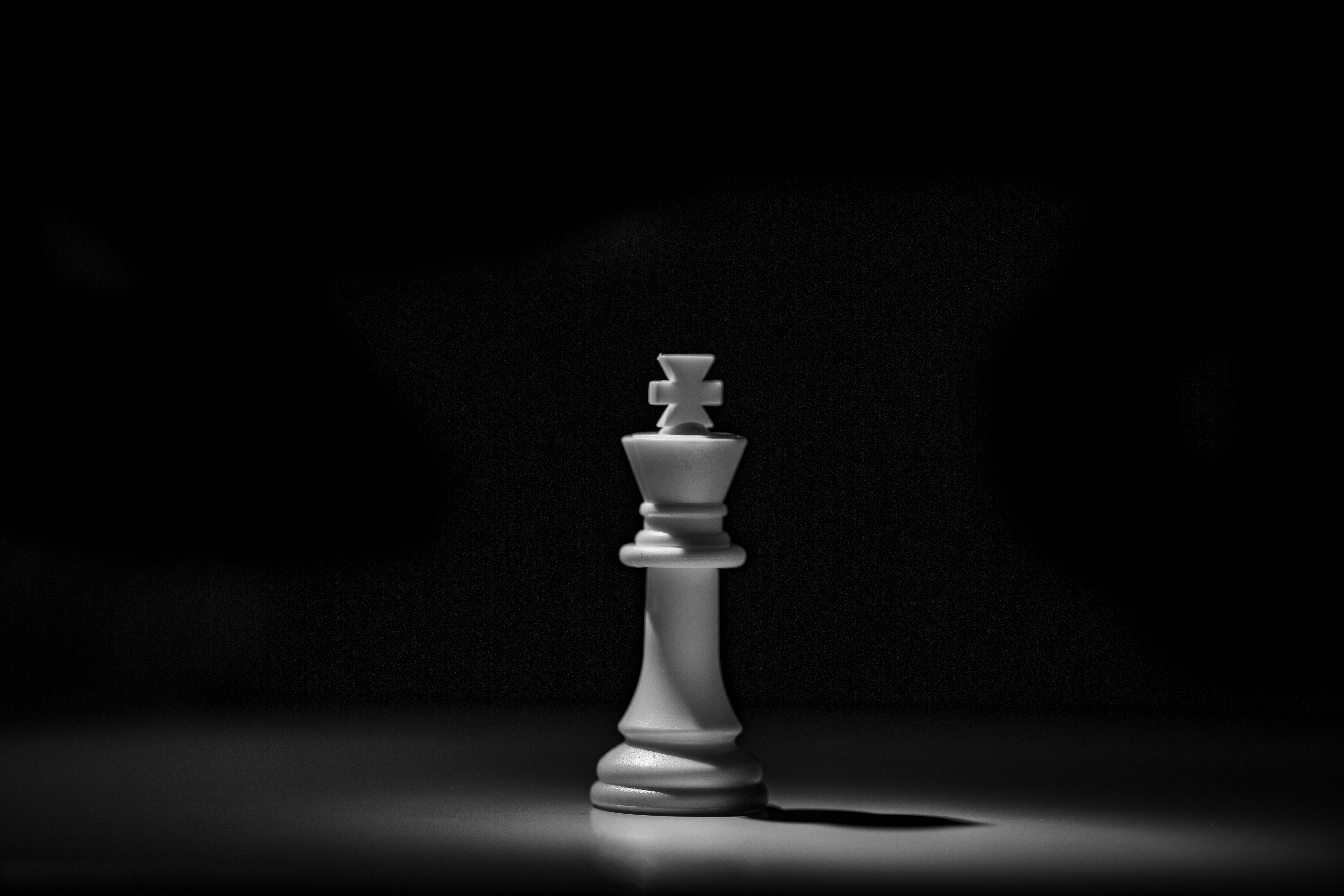 white king chess piece on black table